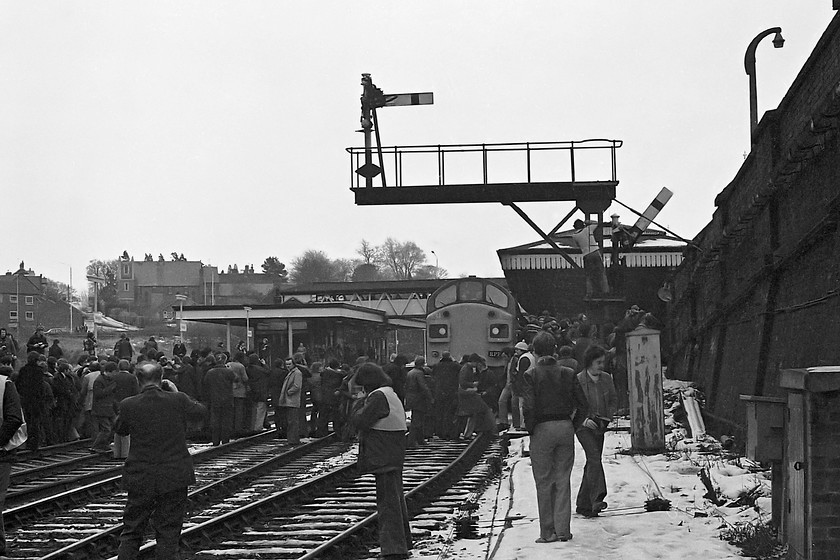 40144, outward leg of The Crewe Campaigner Relief, 07.35 London Paddington-Crewe (1Z68), Wellington station 
 Scenes that are unimaginable today at Wellington station in Shropshire. With snow still lying on the ground, 40144 waits at the platform having arrived with The Crewe Campaigner Relief Railtour that started out form London Paddington. There are a few orange waist-coated marshals about to keep order but the enthusiasts seem to have free reign to wander about and get their pictures. Notice that there is even one who has climbed the signal post to get his shot, I wonder if the picture that he took is still in existence? 
 Keywords: 40144 The Crewe Campaigner Relief 07.35 London Paddington-Crewe 1Z68 Wellington station