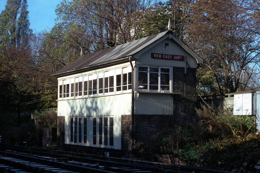 Kew East Junction Signal Box (NL, C. 1900) 
 With frost from the previous night still on the sleepers, Kew East Junction signal box is seen in the morning sun. This North London box was constructed circa 1900 and looked smart but for the temporary roof repair made out of roofing felt! In later years it had a proper roof constructed of slate but at the same time, it also had the UPVC tretament. The box closed in June 2012 with control moving to Acton Wells. 
 Keywords: Kew East Junction Signal Box