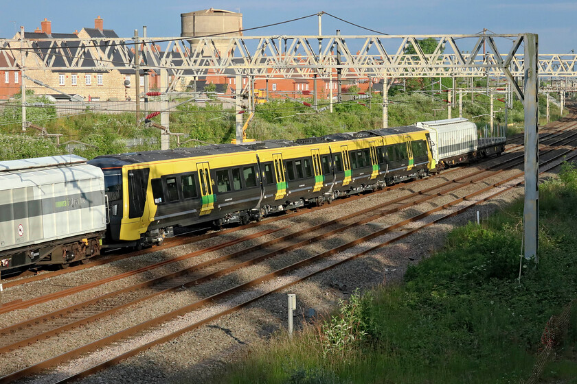 Class 777 (777035?), 18.31 Wembley Yard-Walton Old Junction (6Q77, RT), site of Roade station 
 I believe this unit to be 777035 and that it is the final Merseyrail unit to be delivered. It is seen passing Roade as the 6Q77 18.31 Wembley Yard to Walton Old Junction. Out of sight at the front former Grand Central HST power cars 43480 and 43468 now Railadventure liveried and operated are towing the train. I saw one of the very first deliveries deep in the middle of the first COVID lockdown also passing Roade, see.... https://www.ontheupfast.com/p/21936chg/29021665404/x777004-02-44-dollands-moor-kirkdale 
 Keywords: Class 777 777035 18.31 Wembley Yard-Walton Old Junction 6Q77 site of Roade station