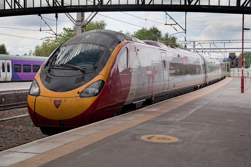 390119, VT 15.15 Manchester Piccadilly-London Euston (1A49), Stoke-on-Trent station 
 The second train that was part of my rather convoluted journey home arrives at Stoke-on-Trent station. 390119 arrives at Stoke with the 15.15 Manchester Piccadilly to Euston that I took as far as Milton Keynes Central. Interestingly, I saw this particular Pendolino a short time earlier at Crewe on its down working to Manchester. 
 Keywords: 390119 15.15 Manchester Piccadilly-London Euston 1A49 Stoke-on-Trent station