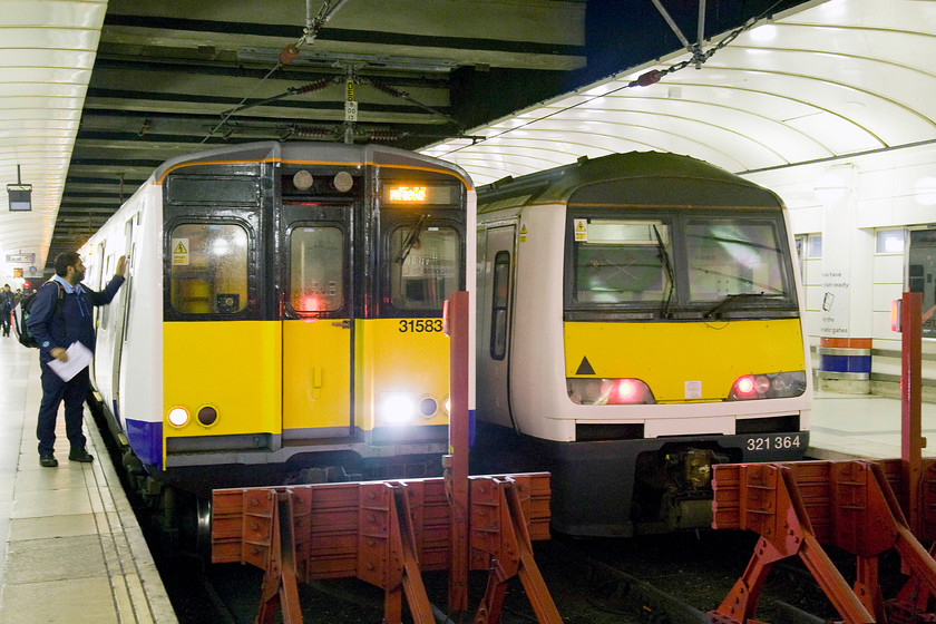 Class 315, LO 10.34 Shenfield-London Liverpool Street (2W86) & 321364, LE ECS from 09.00 Braintree-London Liverpool Street (1F31), London Liverpool Street station 
 A class 315's driver secures his train after arrival with the 10.34 from Shenfield at Liverpool Street. Next to it, sits 321364 stabled after the earlier arrival of the 09.00 from Braintree. I was eyed with suspicion at Liverpool Street station by staff not keen on me having my camera out despite having a valid ticket. If I had been using a mobile 'phone camera, would that have been different? 
 Keywords: 31583? 10.34 Shenfield-London Liverpool Street 2W86 321364 ECS from 09.00 Braintree-London Liverpool Street 1F31 London Liverpool Street station.