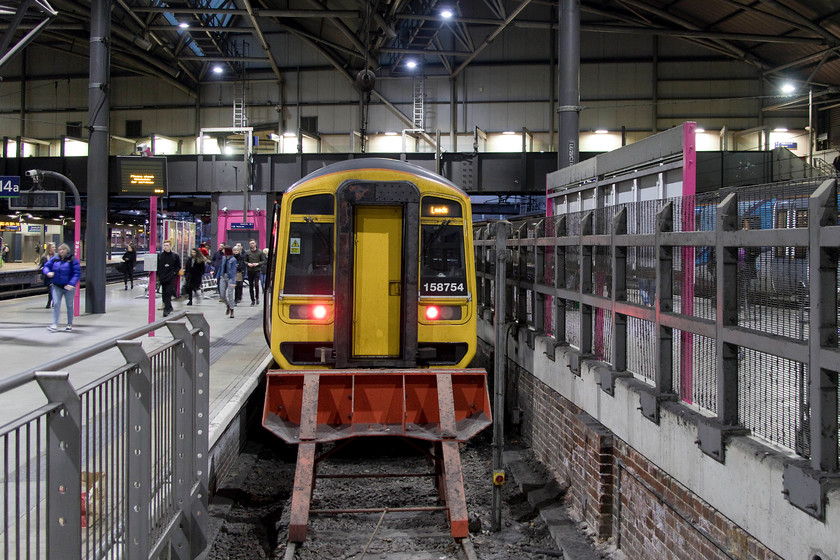 158754, NT 17.26 York-Leeds (2T20, 8L), Leeds station 
 Having arrived back in Leeds, I turned my camera to view 158754 on the blocks with the 17.26 from York. I am a fan of these 1990s BREL built units. They ride well and have large and comfortable seats, quite a contrast to what is being produced new today! 
 Keywords: 158754 17.26 York-Leeds 2T20 Leeds station