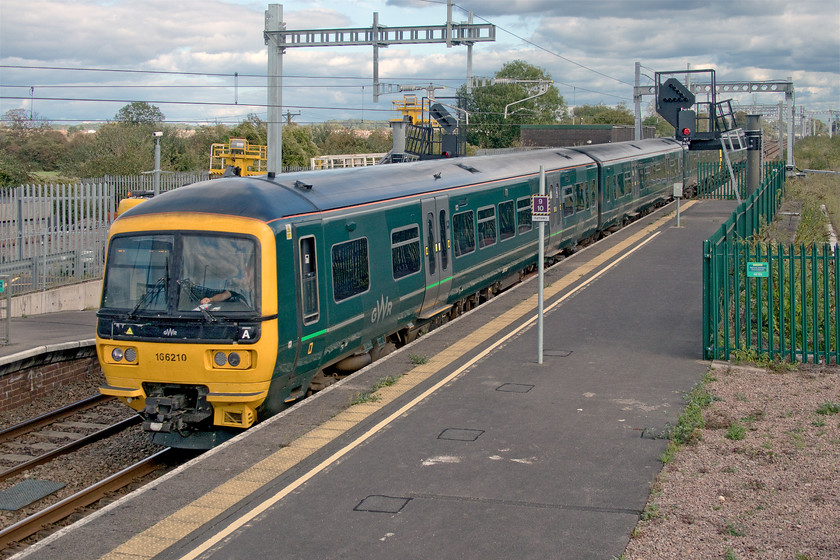 166210 & 165122, GW 11.23 Portsmouth Harbour-Cardiff Central (1F16, RT), Severn Tunnel Junction station 
 166210 and 166122 speed through Severn Tunnel Junction station having just emerged from the depths of the tunnel of the same name, working the 11.23 Portsmouth Harbour to Cardiff Central train. This view is from the new and absolutely monstrous footbridge at the station that, despite its size, offers very few views of the lines around the station due to its high parapets and the electrification masts. Behind the tall tree above the train was the location of the Severn Tunnel Junction steam shed (86E) and the huge water tower that stood for many years after the shed closed in 1965. 
 Keywords: 166210 and 165122, GW 11.23 Portsmouth Harbour-Cardiff Central 1F16 Severn Tunnel Junction station