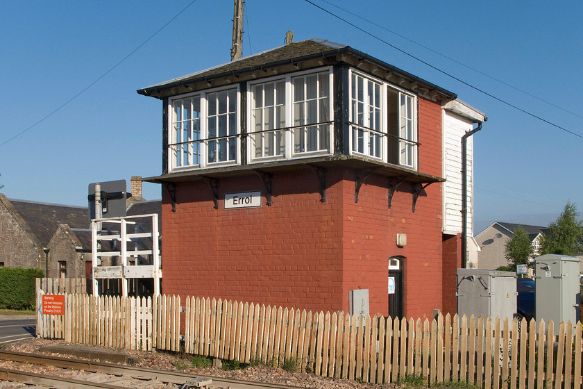 Errol signal box (Caledonian, 1877) 
 The fine and now rare 1877 Type 1 Caledonian signal box at Erol basks in the early morning summer sun. Whilst the ugly extension to the rear of the box spoils the proportions of somewhat it still retains a slate roof and timber barge boarding. The box is a B listed structure by Historic Environment Scotland. 
 Keywords: Errol signal box Caledonian