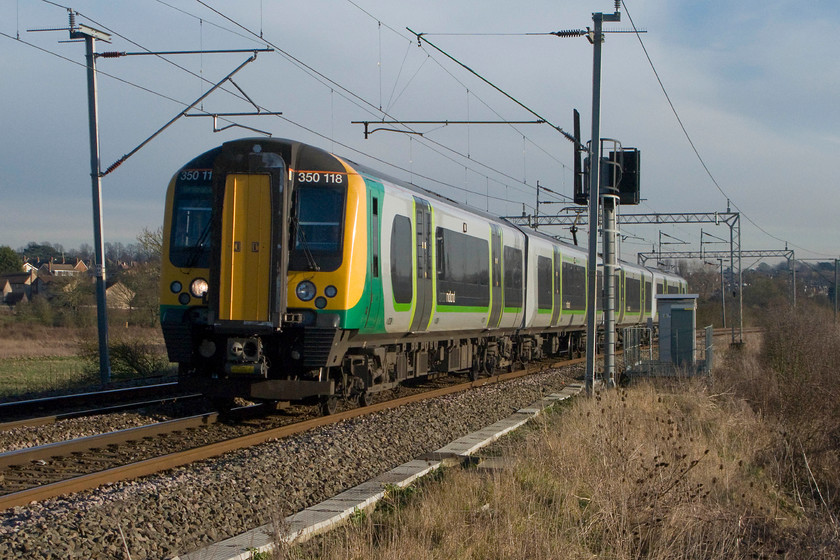 350118, LM 13.13 Euston-Birmingham New Street (1Y39), Wilson`s Crossing 
 350118 makes a fine sight (if a Desiro can be such a thing!) as it accelerates away from Northampton with the 13.13 Euston to Birmingham New Street service. The picture is taken at Wilson's Crossing that is a footpath crossing over the line near Kingsthorpe to the north of Northampton. 
 Keywords: 350118 13.13 Euston-Birmingham New Street 1Y39 Wilson`s Crossing