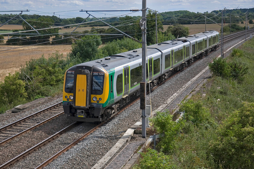 350129, LM 10.28 London Euston-Birmingham New Street (2Y14), Blisworth 
 In the hot summer sunshine Desiro 350129 works the 10.28 Euston to Birmingham new Street past Blisworth off it normal route. With the closure of the Northampton line for engineering work this London Midland service is taking the Weedon line sharing its path with a raft of Virgin pendolinos. 
 Keywords: 350129 10.28 London Euston-Birmingham New Street 2Y14 Blisworth London Midland Desiro