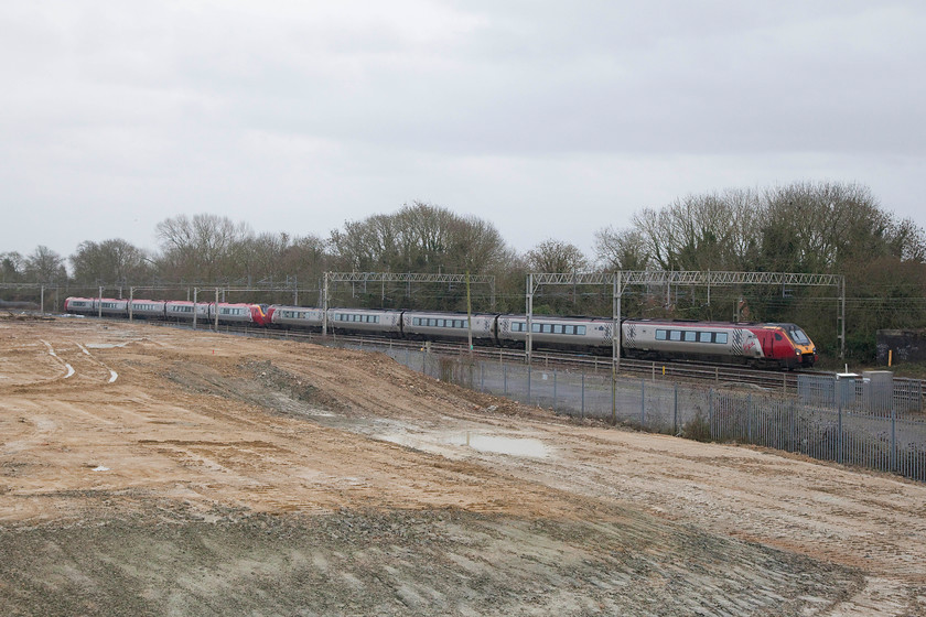 Class 221s, VT 12.10 London Euston-Chester (1D86), Site of Roade station 
 Two class 221s pass the site of the long closed Roade station with the 12.10 Euston to Chester. The flattened land in the foreground marked the site of the old Pianoforte factory that has been cleared to make way for a huge new housing development. 
 Keywords: Class 221s 12.10 London Euston-Chester 1D86 Site of Roade station