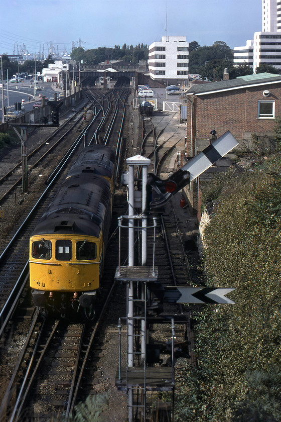 33017 & 33014, up LEs, Southampton Tunnel 
 Taken from the top of the tunnel mouth with Southampton station in the background, 33017 and 33014 pass light engine probably heading for Eastleigh. They are passing a superb upper quadrant signal controlled by Southampton Central signal box that was, and still is for that matter, located at the western end of the station thus out of sight in this view. Notice the mass of cranes on the horizon associated with the nearby docks. 
 Keywords: 33017 33014 Southampton Tunnel