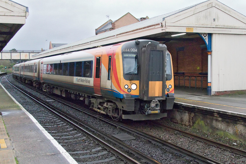 444004, SW 14.03 Weymouth-London Waterloo (1W22, RT), Christchurch station 
 444004 arrives at Christchurch station with the 14.03 Weymouth to London Waterloo. The station is located a considerable distance to the north-west of the town making it not the most convenient location for the seasonal visitors to the town who choose to use the train. 
 Keywords: 444004 14.03 Weymouth-London Waterloo 1W22 Christchurch station South Western Railway SWR