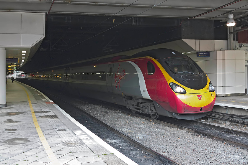 390002, VT 11.47 Wolverhampton-London Euston (1B18), Birmingham New Street station 
 The 11.47 Wolverhampton to London Euston Virgin service pauses at Birmingham New Street. These Pendolinos are synonymous with many services on this route and those via the Trent Valley. Like so many things on our railways, we get so accustomed to everyday 'normal' events such as this but what about when they are moved on elsewhere or even withdrawn, they then become a memory and these pictures take on a whole new importance. 
 Keywords: 390002 11.47 Wolverhampton-London Euston 1B18 Birmingham New Street station