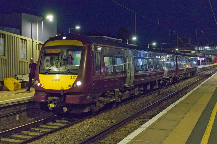 170517, EM 21.04 Peterborough-Newark Northgate (2K30, RT), Peterborough station 
 The driver of 170517 walks forward to check the front lighting of the Turbo unit just prior to its departure from Peterborough. The 2K30 21.30 service to Newark will take a somewhat circuitous route via Spalding, Sleaford and Lincoln taking two hours to complete its journey. A quick nip along the ECML would take about thirty minutes! 
 Keywords: 170517 EMR 21.04 Peterborough-Newark Northgate 2K30 Peterborough station turbo East Midlands Railway