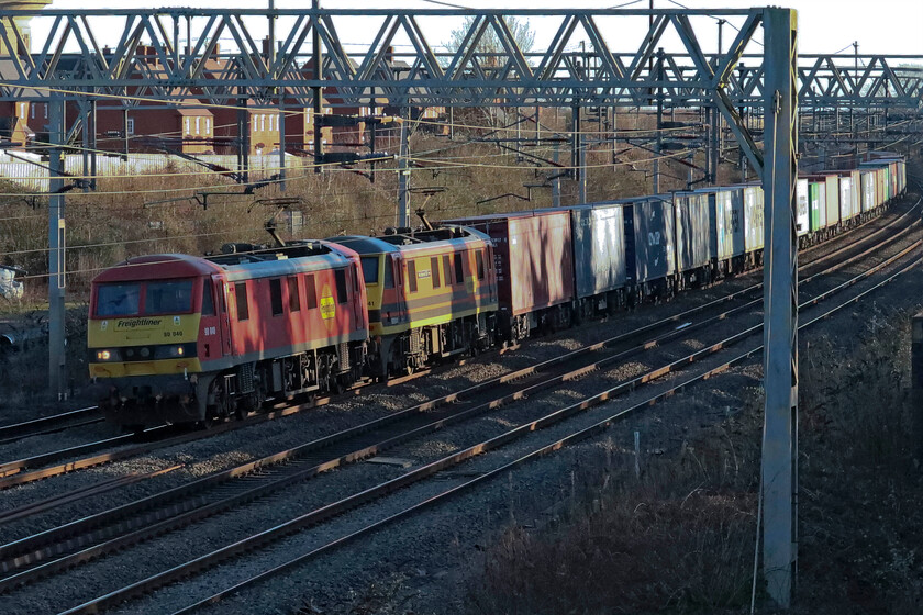 90040 & 90041, 09.12 Felixstowe North-Trafford Park (4M63, 3E), site of Roade station 
 The 09.12 Felixstowe North to Trafford Park Freightliner is usually double-headed by a pair of Freightliner's finest Class 90s and today is no exception. The well-loaded train is seen passing Roade catching some welcome late afternoon winter's sunshine on this particularly chilly day. 'Leading is 90040 with consecutively numbered 90041 'Pete Waterman OBE' tucked in behind. After such a busy day nipping in and out to catch the various late-running infrastructure trains it's time to head home for a cuppa now, I think! 
 Keywords: 90040 90041 09.12 Felixstowe North-Trafford Park 4M63 site of Roade station Freightliner Pete Waterman OBE