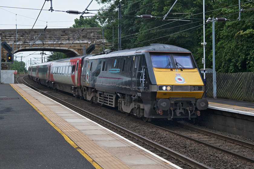 91110, GR 12.30 London King`s Cross-Edinburgh Waverley (1S17, 34L), Almouth station 
 91110 'Battle of Britain Memorial Flight' passes Alnmouth station with the 12.30 King's Cross to Edinburgh Waverley. Alnmouth is a busy station that serves the nearby tourist honeypot of Alnwick. There are ambitious plans to re-open the branch line to the town that was closed in 1968. If these plans ever came to fruition, a new terminus would be needed as the old one is now home to the superb Barter Books, see.. https://www.barterbooks.co.uk/index.php 
 Keywords: 91110 12.30 London King`s Cross-Edinburgh Waverley 1S17 Almouth station