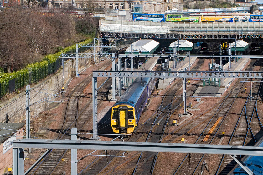 158867, SR 14.33 Edinburgh Waverley-Dumblane, Edinburgh Waverley station from The Mound 
 After the unseasonally cold weather, a bit of afternoon sunshine gladdens the heart! Standing in the gardens on The Mound just in front of the National Gallery of Scotland affords a commanding view of the western throat of Waverley station, a view spilt somewhat by the wiring infrastructure. 158867 leaves the station with the 14.33 service to Dumblane. 
 Keywords: 158867 14.33 Edinburgh Waverley-Dumblane Edinburgh Waverley station from The Mound