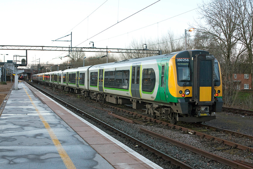 350258, stabled, Northampton Riverside 
 350258 and a classmate sit at Northampton Riverside sidings awaiting their next turn. Since the opening of the Siemens EMUD the Riverside sidings do not see quite so much use as was the case in the past. 
 Keywords: 350258 Northampton Riverside