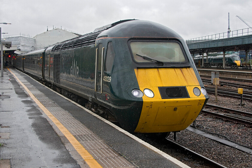 43029, GW 09.00 Cardiff Central-Penzance (2C69, RT), Bristol Temple Meads station 
 The things that we do in the pursuit of our hobby: in absolutely torrential rain 43029 'Caldicot Castle' is captured waiting to leave Bristol Temple Meads with the 2C69 09.00 Cardiff to Penzance service. Having taken the shot with hopefully the right camera settings and reasonably well-composed I dashed back to the shelter of the canopy! Notice that these services carry a Class 2 prefix in their reporting number classifying them as an 'ordinary passenger train'. It seems a bit of a demotion for the HSTs that would have carried a Class 1 prefix throughout their previous working lives. 
 Keywords: 43029 09.00 Cardiff Central-Penzance 2C69 Bristol Temple Meads station GWR HST Caldicot Castle