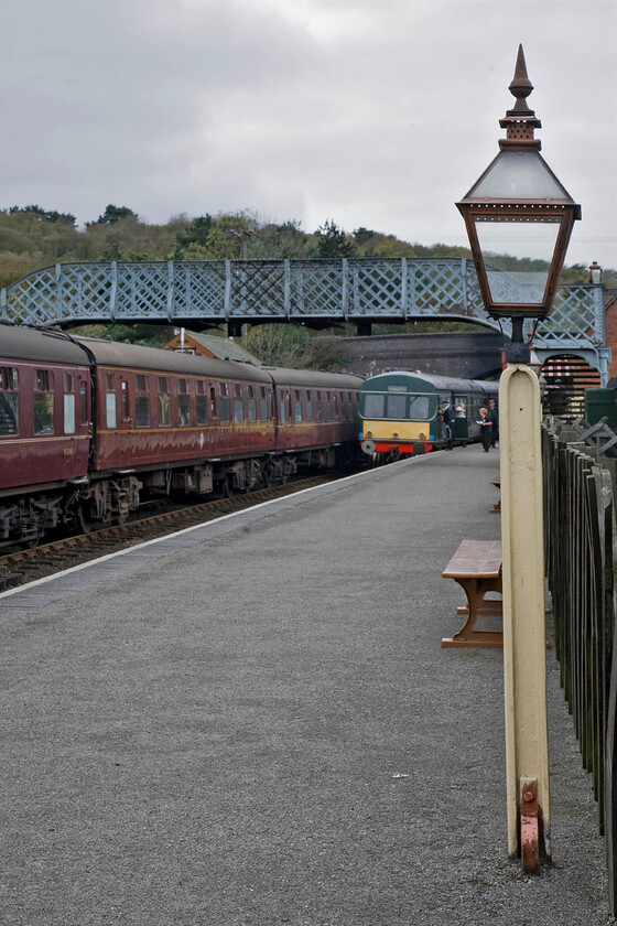 10.30 Sheringam-Holt & M56352 & M51192, 10.30 Holt-Sheringham, Weybourne station 
 A classic scene at Weybourne station from the rake of Mk. 1 maroon stock, the wrought iron footbridge, the Class 101 DMU to the superb reproduction gas lamp! The station is a faithful recreation of an M&GN country station set about 1910 and a fine job has been made of it. In this scene, the 10.30 Sheringham to Holt service is about to get underway with the 10.30 Holt to Sheringham being worked by M56352 and M51192. 
 Keywords: 10.30 Sheringham-Holt M56352 M51192 10.30 Holt-Sheringham Weybourne station Class 101 DMU