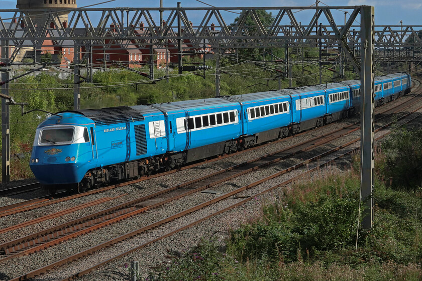 43046 & 43049, 13.08 Wembley Yard-Crewe HS (5Z57, 27L), site of Roade station 
 Following railtour duties the previous day (the Settle to Carlisle & Tyne Valley Pullman) one of LSL's reto. Blue Pullman/HST sets pass through Roade returning to its base at Crewe. 43046 'Geoff Drury 1930-1999' leads with power car 43049 'Neville Hill' at the rear. Having left Wembley Yard on time at 13.08 and running as 5Z57 the train soon ran into difficulties near Berkhamstead where 350111 had brought down the catenary just south of Northchurch Tunnel causing huge delays to all services. The HST is seen here over an hour late but through some spirited running and favourable signalling decisions, it arrived at Crewe just twenty-seven minutes late. 
 Keywords: 43046 43049 13.08 Wembley Yard-Crewe HS 5Z57 site of Roade station Midland Pullman LSLGeoff Drury 1930-1999 Neville Hill