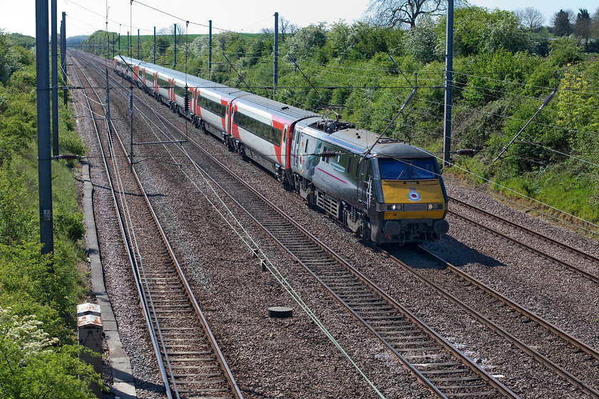 91110, GR 09.30 London King`s Cross-Edinburgh (1S10, 1E), Swayfield SK994231 
 In its unmistakeable unique livery, 91110 'Battle of Britain Memorial Flight' leads the 1S10 09.30 King's Cross to Edinburgh up Stoke Bank. This service was running fairly late at this point, time that it largely made up by the time it reached Scotland. The train is seen, somewhat compromised by the catenary, passing Swayfiled between Peterborough and Grantham. 
 Keywords: 91110 09.30 London King`s Cross-Edinburgh 1S10 Swayfield SK994231