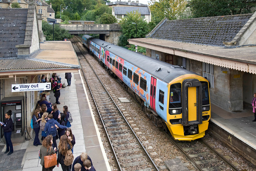 158798, GW 13.23 Portsmouth Harbour-Cardiff Central (1F20), Bradford-on-Avon station 
 When I was a schoolboy at Bradford-on-Avon's St. Lawrence School comprehensive (or Trinity secondary modern as it was then) see.... http://st-laurence.org/Trinity.html very few pupils used the train to get to and from school. This situation appears to have changed today with the platform engulfed by pupils making their way home. This is even more of a surprise as the station is some distance from the school with a dirty great big hill to be climbed in the morning! In this photograph, 158798 arrives with the 13.23 Portsmouth Harbour to Cardiff Central service. This set carries a one-off all-over vinyl applied four months ago promoting the Springboard Opportunity Group that supports children in North Somerset with additional needs. 
 Keywords: 158798 13.23 Portsmouth Harbour-Cardiff Central 1F20 Bradford-on-Avon station