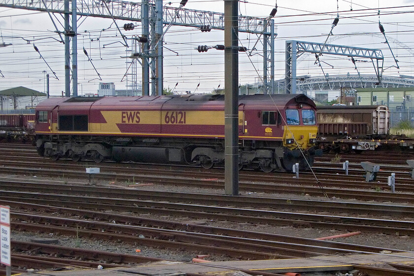 66121, stabled, Wembley Yard 
 Still wearing its defunct EWS livery and full branding 66121 sits in Wembley Yard awaiting it next trun of duty. With the takeover of EWS by Deutsche Bahn now nearly six years past the German-owned company appears to be under no compunction to repaint their assets! 
 Keywords: 66121 Wembley Yard