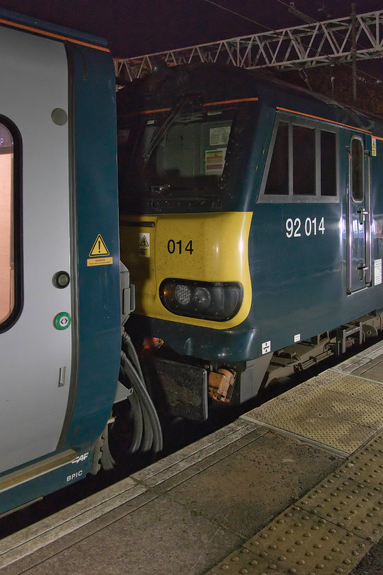 92014 (to Carstairs), CS 23.36 London Euston-Glasgow Central & Edinburgh Waverley sleeper (via Manchester) (1S26, 1B26, RT), London Euston station 
 92014 waits at the head of the Lowland sleeper service, the 23.36 to Glasgow Central and Edinburgh. The more observant will spot that this departure time is a little earlier than normal, this was due to the train being diverted via Manchester Piccadilly and Parkside Junction (to re-join the WCML) because of the engineering works being undertaken to replace Weaver Junction. 92014 hauled the train to Carstairs where the train split, it then took the Glasgow portion on with 92020 taking the Edinburgh portion. 
 Keywords: 92014 23.36 London Euston-Glasgow Central Edinburgh Waverley sleeper 1S26 1B26 London Euston station