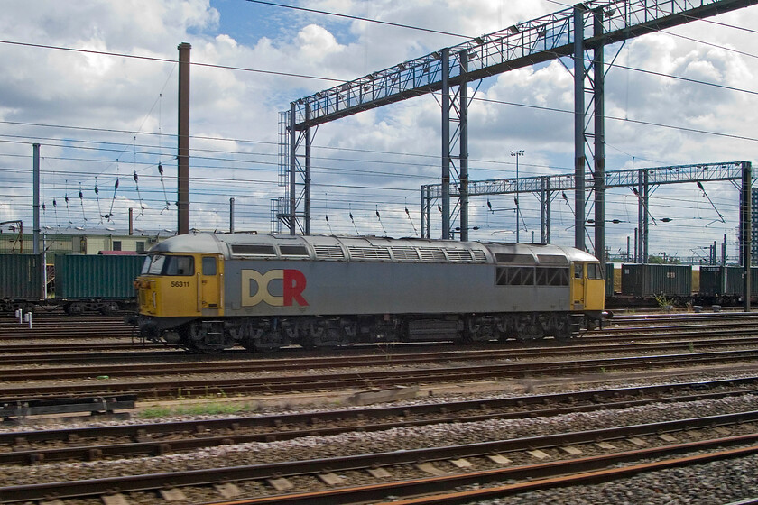 56311, stabled, Wembley Yard 
 Taken from our Southern service as we pass slowly past Wembley Yard DCR's 56311 is seen stabled. With DCR now focussing solely on more lucrative and growing construction traffic the powerful type 5 locomotive is ideally suited for such work if being a little long on the tooth! 
 Keywords: 56311 Wembley yard DCR Devon & Cornwall Railway