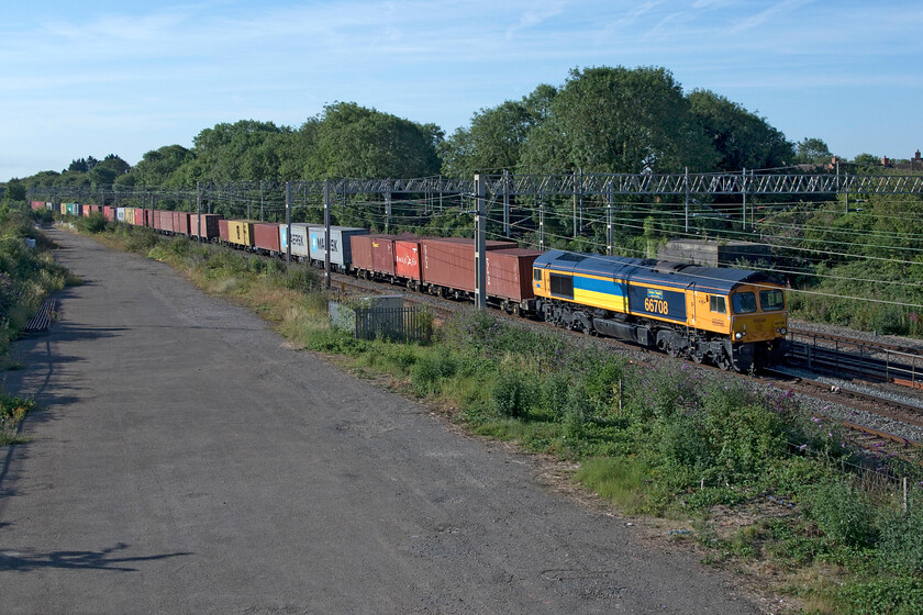 66708, 03.15 Felixstowe North-Trafford Park (4M18, 5E), site of Roade station 
 Since its unveiling and naming on 02.05.22 at Eastleigh this is the first time that I have seen 66708 'Glory to Ukraine' . It is leading the regular morning 4M18 03.15 Felixstowe to Trafford park Freightliner and is passing the site of Roade's former station taken from the colloquially named gravel bridge. 
 Keywords: 66708 03.15 Felixstowe North-Trafford Park 4M18 site of Roade station Glory to Ukraine