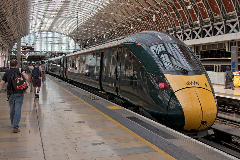 802011, GW 13.38 London Paddington-Swansea (1B17, 4L), London Paddington station 
 Passengers make their way along platform nine at Paddington station to join the 13.38 GWR service to Swansea. On this day the 1B17 is being worked by 802011 'Sir Joshua Reynolds' and another unidentified Class 802 at the front. Whilst a number of shorter formed units may offer a greater degree of flexibility I really cannot help but feel that double manning of a train to South Wales is not the best use of staffing and was this really thought through when these trains were procured? 
 Keywords: 802011 13.38 London Paddington-Swansea 1B17 London Paddington station GWR IET Sir Joshua Reynolds