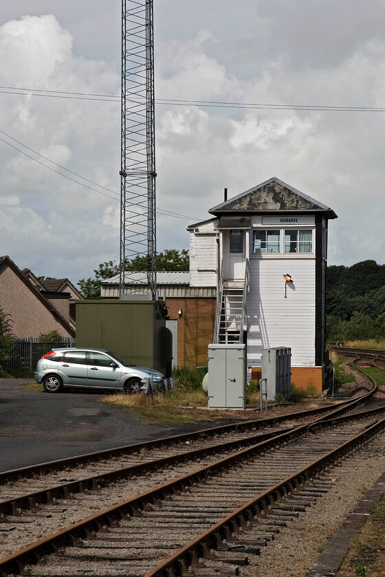 Annan signal box (GSW, 1876) 
 The GSWR Type 1 signal box at Annan is seen from the station's platform end. The box was built in 1876 with its heritage recognisable by its pyramidal hipped roof despite the cloak of UPVC cladding. Quite how it has remained open is a mystery as it is an outpost of mechanical signalling sandwiched between more modern colour lights controlled from Dumfries. Whatever the reason for its survival, it looks good in the morning sunshine! 
 Keywords: Annan signal box GSW Glasgow and South Western Railway