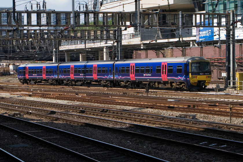 165112, GW 12.57 London Paddington-Oxford, London Paddington station 
 Basking in some welcome sunshine 165112 leaves Paddington station working the 12.57 to Oxford. These Tames Turbos units have been the mainstay of these services, as well as others to Reading, Newbury and Bedwyn for many years now but with the forthcoming electrification they will be ousted in the future that is the wires ever get strung! 
 Keywords: 165112 12.57 London Paddington-Oxford London Paddington station FGW Turbo First Great Western