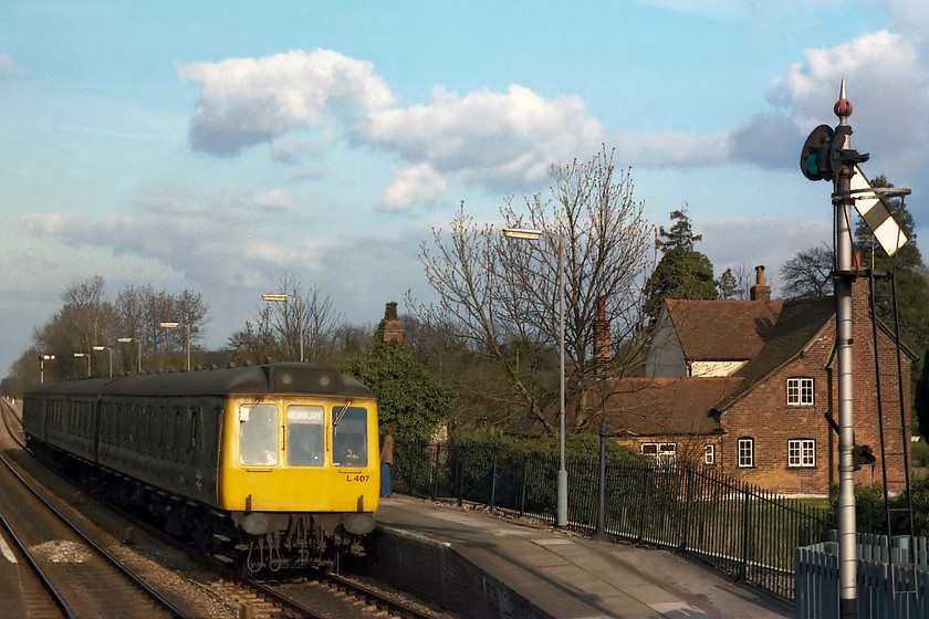 L407, unidentified London Paddington-Bedwyn working, Kintbury station 
 A class 117 DMU set number L407 comes to a halt at Kintbury station with an unidentified Paddington to Bedwyn service, next stop Hungerford. The starter is already pulled off with the home returned to danger. The photograph is taken from the steps of Kintbury signal box that only had a matter of a few hours left in use before closure. 
 Keywords: L407 unidentified London Paddington-Bedwyn working Kintbury station