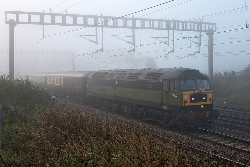 D1935, outward leg of The Settle & Carlisle Coastal Statesman, 07.04 Milton Keynes Central-Appleby (1Z77, 5L), Roade Hill 
 I could hear D1935 Roger Hosking MA 1925-2013 for some time before I could actually see it here between Roade and Ashton in Northamptonshire! Formally 47805, 47650 and 47257 the 1966 built Type 4 is seen leading the outward leg of The Settle & Carlisle Coastal Statesman charter that has just left its starting point at Milton Keynes. 
 Keywords: D1935 The Settle & Carlisle Coastal Statesman, 07.04 Milton Keynes-Appleby 1Z77 Roade Hill Roger Hosking MA 1925-2013