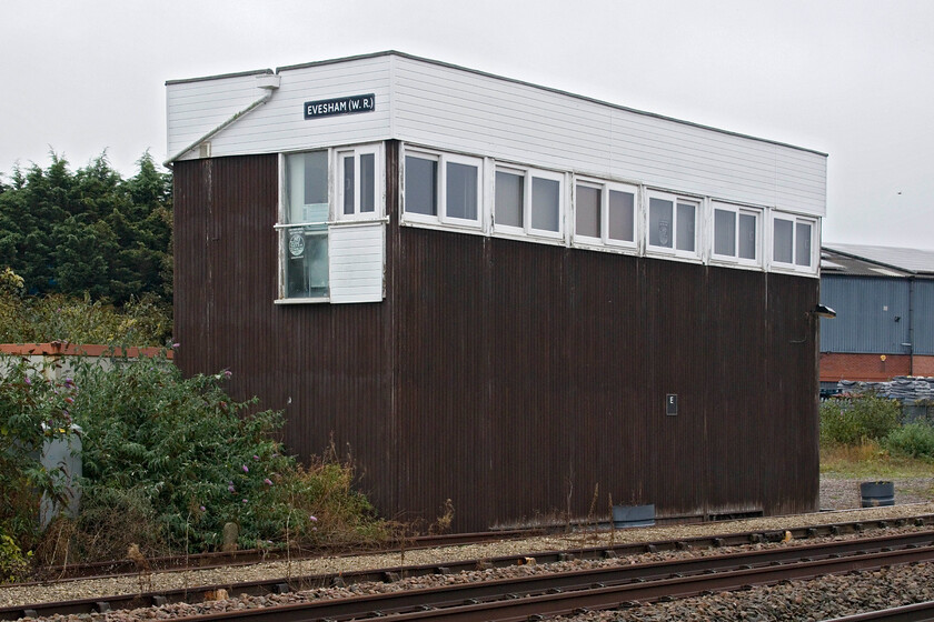 Evesham (WR) signal box (BR, 1957) 
 Evesham's British Railways built 1957 signal box is seen taken over a fence from inside an industrial estate. The timber-clad structure is similar to a number of others built around the same time. Whilst not the most attractive structure at least it contains a proper frame that operates an array of local semaphores. Notice the nameboard of the box incorporates WR (Western Region) in its title. This differentiated it from the town's other box which was located at the Midland station that closed to traffic in 1964. 
 Keywords: Evesham WR signal box