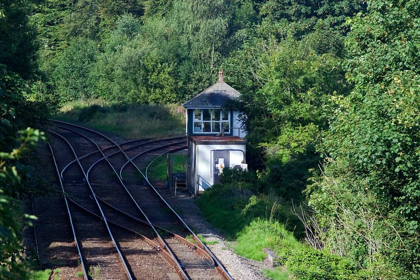 Dalton Junction signal box (Furness, 1902) 
 When I photographed this lovely box in October 1985, I managed a full fronted 3/4 shot from high up on the bank to the left. I tried to replicate the shot this time but was tharwted by excessive growth on the embankment. This is a shame as there is no other way to get close to it apart from the road bridge as here. Dalton Junction was built by the Furness Railway to its final box design and was opened in 1902 when the short link line was opened to save trains having to make the huge diversion into Barrow. 
 Keywords: Dalton Junction signal box