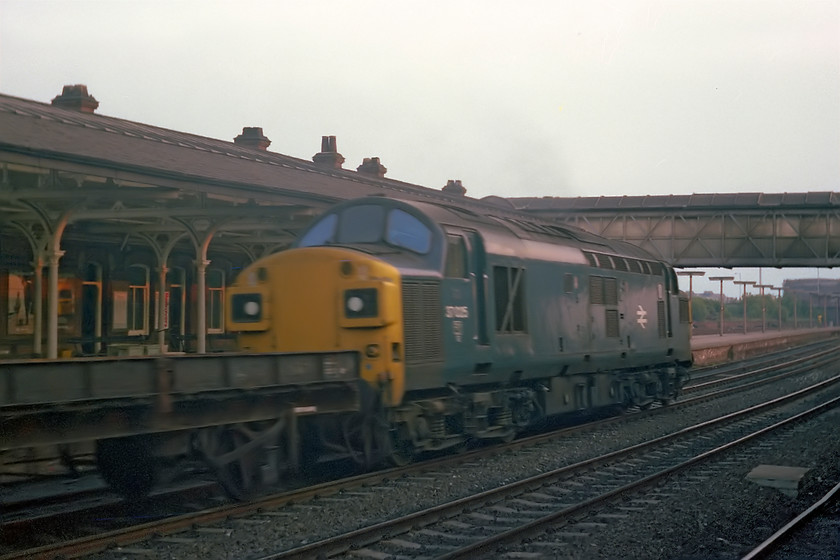 37025, up freight, Selby station 
 Split headcode 37025 heads south through Selby station with an unidentified freight working. Despite the subject being a little out of focus, I love the lighting in this image looking in the general direction of the setting sun. After 37 years in service, 37025 did not quite make it into the millennium being condemned in 1999. 
 Keywords: 37025 up freight Selby station