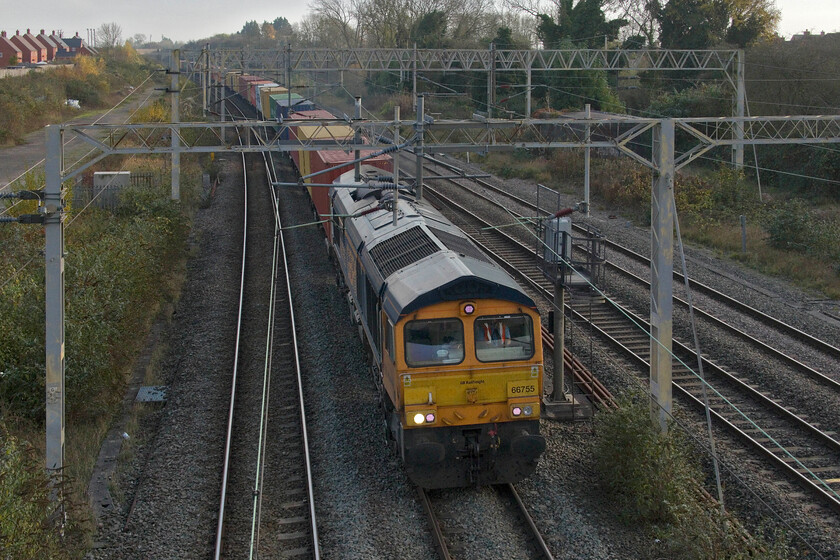 66755, 12.32 Wembley Yard-Hams Hall (4G13, 5E), site of Roade station 
 Seen yesterday heading south at Wolverton 66755 'Tony Berkeley OBE RFG Chairman 1997-2018' returning north leading the Sunday 4G13 12.32 Wembley Yard to Hams Hall service. The train is seen passing through Roade in decidedly better weather than it was seen yesterday morning, see.... https://www.ontheupfast.com/p/21936chg/30062313619/x66755-06-21-hams-hall-london-gateway 
 Keywords: 66755 12.32 Wembley Yard-Hams Hall 4G13 site of Roade station Tony Berkeley OBE RFG Chairman 1997-2018