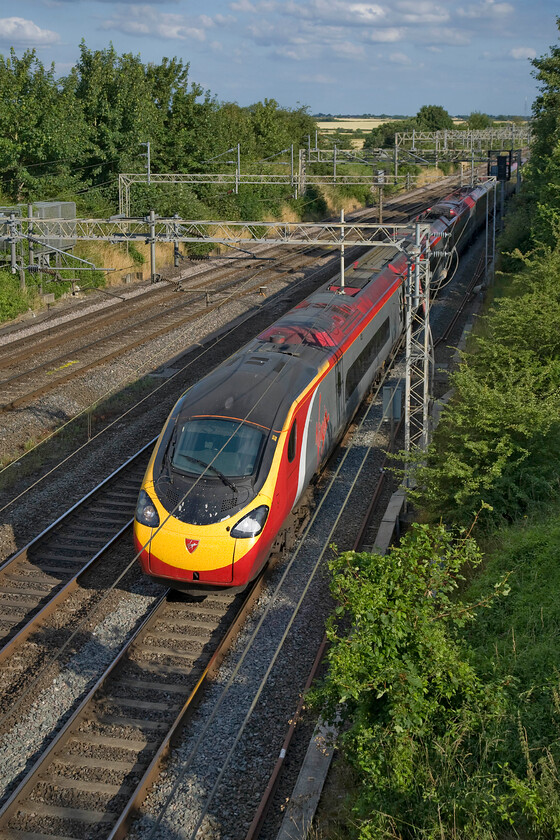 390044, VT 17.43 London Euston-Glasgow Central (9S97), Victoria bridge 
 In superb evening light, 390044 passes Victoria bridge working the 9S97 17.43 Euston to Glasgow. Sunny summer days more often than not create a very contrasty light with deep shadows and often with a hazy background with evenings like this making a pleasant change hence why I took my camera when I dropped my son to his piano lesson! 
 Keywords: 390044 17.43 London Euston-Glasgow Central 9S97 Victoria bridge Virgin West Coast Pendolino