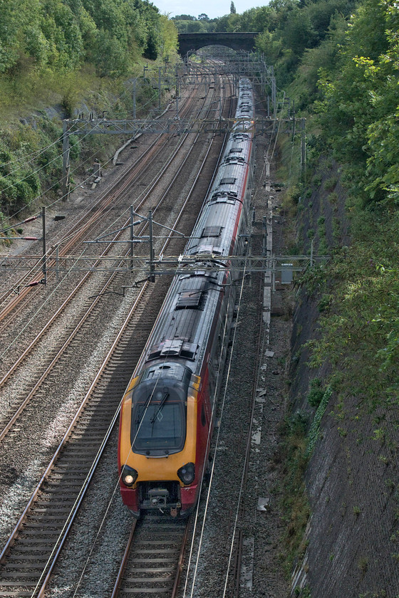 Class 221s, 13.03 London Euston-Birmingham New Street (9G22, 4L), Roade cutting 
 A pair of Avanti West Coast Class 221s pass through Roade cutting working the 13.03 Euston to Birmingham New Street 9G22 service. A few months ago the future of the West Coast Voyagers seemed assured with them moving to another operator with the ordering of a fleet of brand new bi-mode Class 80X units. However, it seems that COVID-19 has struck again with this order now on hold. So the diesel Voyagers may well be seen and heard operating under the wiring for a while longer yet. 
 Keywords: Class 221 13.03 London Euston-Birmingham New Street 9G22 Roade cutting