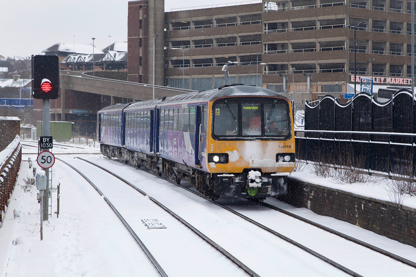 144016, NT 11.36 Sheffield-Huddersfield (2B44, 36L), Barnsley station 
 Northern Rail Pacer 144016 draws into Barnsley station with the 11.36 Sheffield to Huddersfield. It has just crossed over the Jumble Lane level crossing. A signal box with the same name once existed at the platform end just behind the middle carriage of the Pacer. This box was demolished in spring 2005 having been out of use for some years. 
 Keywords: 144016 2B44 Barnsley station