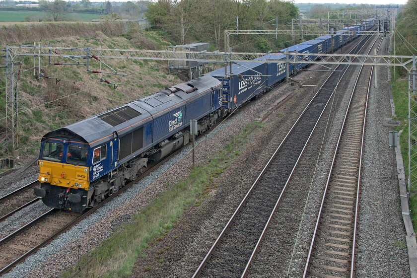 66432, 08.02 Tilbury-DIRFT (4M07, RT), Victoria bridge 
 The 08.02 4M07 Tilbury to Daventry Tesco Express is pretty well loaded on this Saturday lunchtime. There have been periods in the last few months when this train has been running very short and light with just a handful of boxes but I suppose this is due in no small part to the economic trading uncertainties being experienced at the moment. Frequently photographed by me, DRS' 66432 is leading the train. 
 Keywords: 66432 08.02 Tilbury-DIRFT 4M07 Victoria bridge Tesco Express