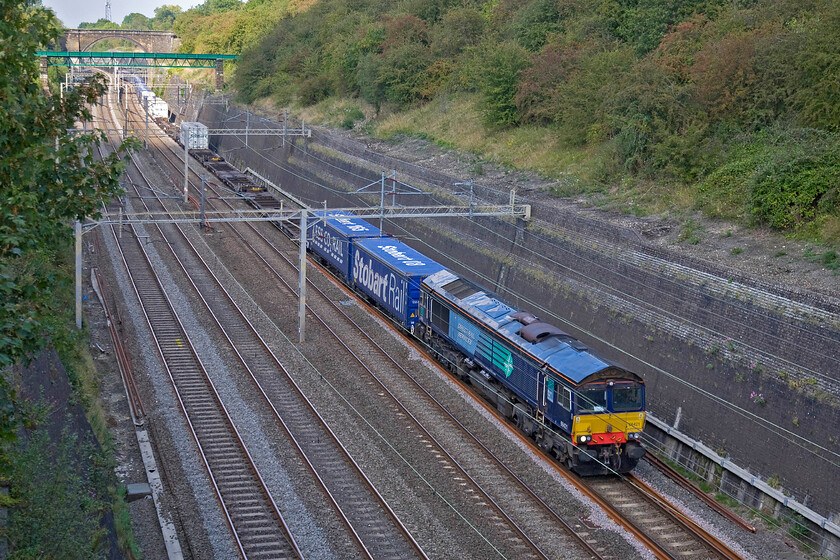 66421, 12.37 DIRFT-Purfleet (4L48), Roade cutting 
 Just missing the sun deep in the cutting due to an errant cloud regular DRS stalwart 66422 leads the equally as regular 4L48 12.37 Daventry (DIRFT) to Purfleet container train. With no more interesting trains due it was now time to walk the short distance to the village hall to donate blood! 
 Keywords: 66421 12.37 DIRFT-Purfleet 4L48 Roade cutting DRS Direct Rail services