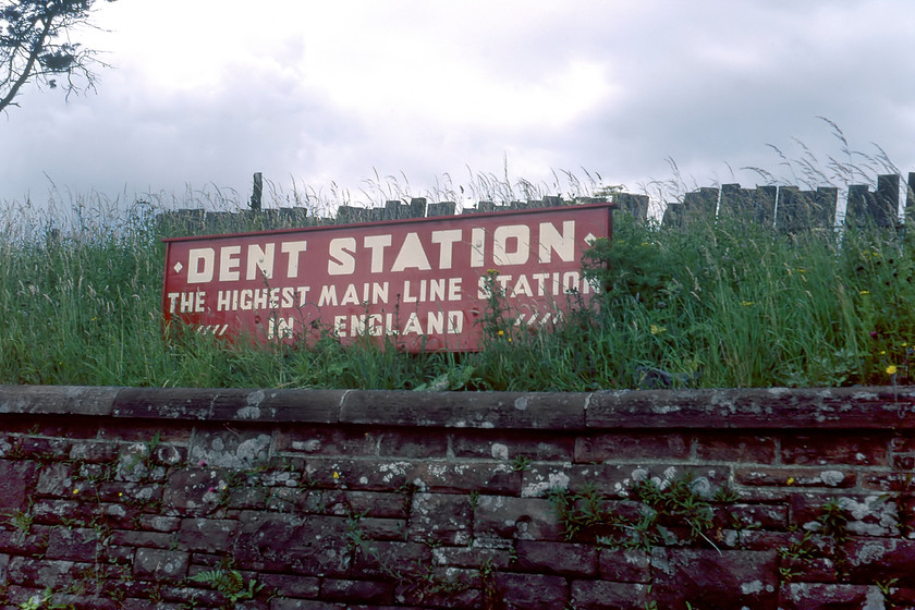 Sign, Dent Station 
 A slightly misleading sign at Dent station. Yes, the station is the highest station in England at one thousand one hundred and fifty feet above sea level. However, when this photograph was taken in 1980 it was not as it was closed! BR shut the station in 1970 as part of its deliberate, coordinated and synical running down of the Settle and Carlisle line dragging it, we all thought, towards inevitable closure. However, as we are all aware this did not happen with Dent station being reopened on 14.08.86. The sign exists today but has been redesigned and now having the actual altitude as part of the wording. 
 Keywords: Sign Dent Station