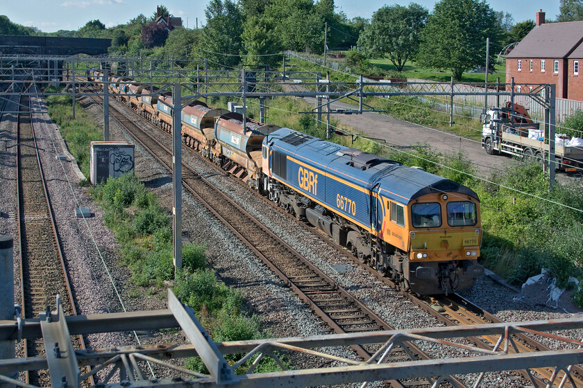 66770, 14.53 Bescot Yard-Wembley Yard (6G52, RT), site of Roade station 
 It is not usual for infrastructure trains to run on Saturdays but in this case, the 14.53 Bescot to Wembley Yard was sent south as 6G52 in preparation for overnight engineering works in north London. Interestingly, I also saw 66770 on an infrastructure working at the same location over a year previously but heading north on that occasion, see..... https://www.ontheupfast.com/p/21936chg/28612412204/x66770-13-15-milton-keynes-central 
 Keywords: 66770 14.53 Bescot Yard-Wembley Yard 6G52 site of Roade station GBRf GB Railfreight