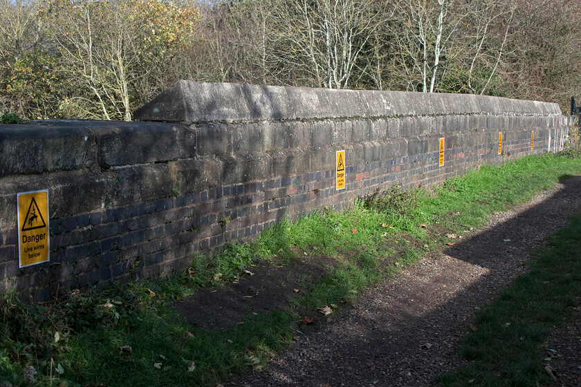 New warning signage, Muddy Lane bridge 
 What on earth! Some busybody with nothing better to do has had a look at the bridges that span Roade cutting and deemed that people need to be warned about the live wires that are positioned some thirty feet below. And not content to install just one sign they have installed twelve of these signs with six on each side. What an utter waste of taxpayers' money but it did give somebody a job to do I suppose.