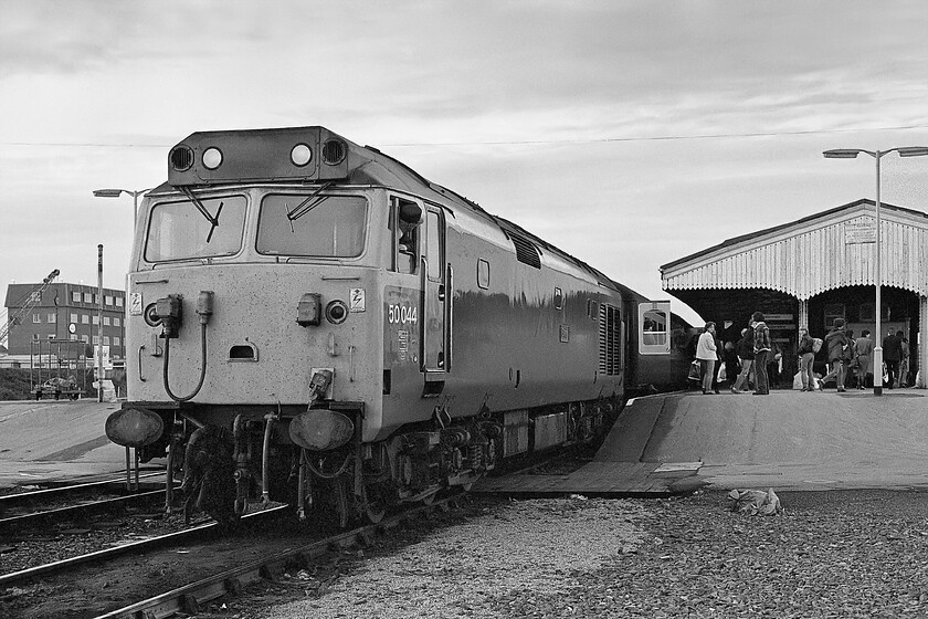 50044, 17.52 London Paddington-Westbury (1K68), Westbury station 
 Having arrived at Westbury station and terminated the 1K68 17.52 ex Paddington services disgorges its passengers who make their ways home this included my A-Level photography group who had enjoyed a great day in London. I am not sure what diagram was followed on the arrival of this service but I suspect 50044 'Exeter' would work the stock back to London again, advice anybody? Notice that I have wandered quite nonchalantly off the platform end to take this photograph; how things have changed! 
 Keywords: 50044 17.52 London Paddington-Westbury 1K68 Westbury station Exeter