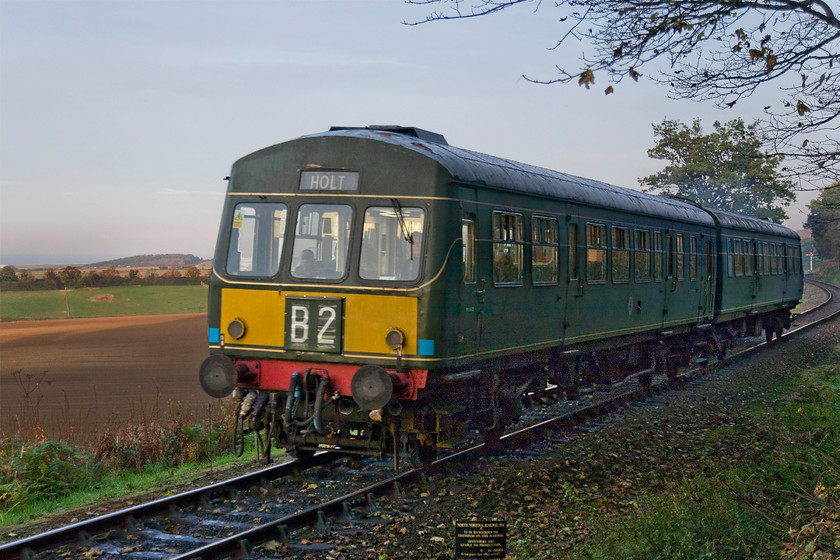 M51192 & M56352, 15.45 Sheringham-Holt, Kelling Heath Halt station 
 In superb late afternoon lighting one of the NNR's resident class 101 DMUs composed of M51192 and M56352 climb Kelling bank with the 15.45 Sheringham to Holt. I must admit to a little Photoshop work to get this image presentable as the camera had exposed properly for the background and sky leaving the foreground chronically underexposed and dark. However, with a little patience, I am pleased with the result that presents a very seasonal and quite atmospheric photograph. 
 Keywords: M51192 M56352 15.45 Sheringham-Holt Kelling Heath Halt station Class 101 DMU