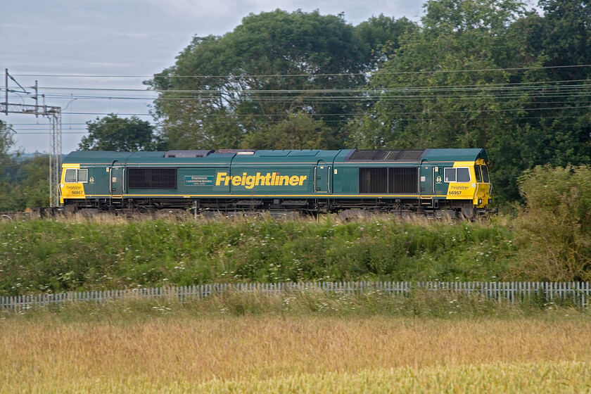 66957, 02.57 Felixstowe North-Garston (4M45, 12E), between Roade & Ashton 
 Just a few minutes behind the previous Freightliner 66957 'Stephenson Locomotive Society 1909-2009' leads the 4M45 02.57 Felixstowe to Garston. Despite running behind the 4M69 here on the approach to Roade this service departed over an hour before the previous one! 
 Keywords: 66957 02.57 Felixstowe North-Garston 4M45 between Roade & Ashton Freightliner Stephenson Locomotive Society 1909-2009