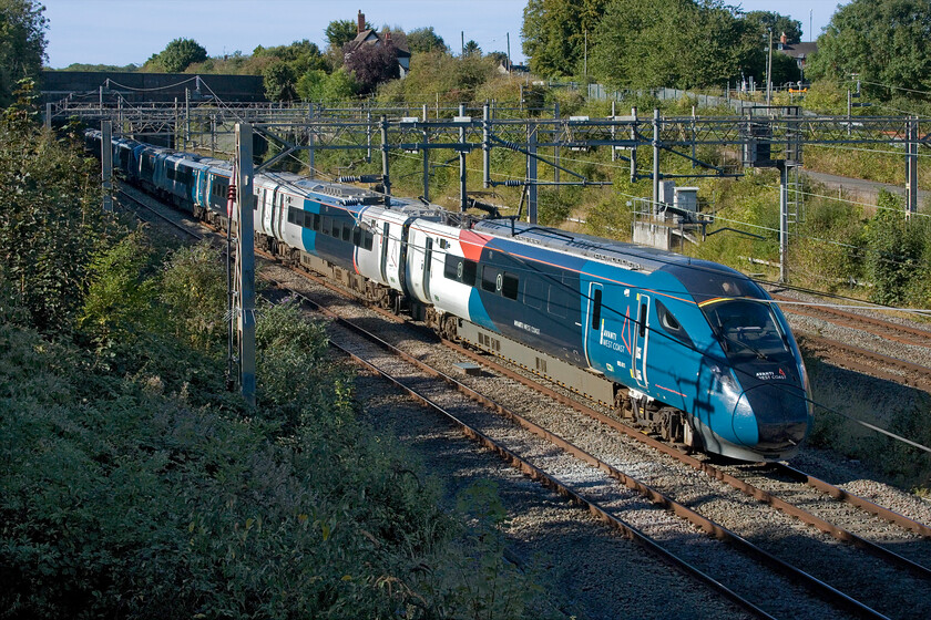 805011 & 805003, VT 12.48 Holyhead-London Euston (1A50, 7L), site of Roade station 
 805011 and 805003 pass Roade in some warm September sunshine working the 12.48 Holyhead to Euston AWC service. The steady introduction of new sets on to the WCML has meant that the site and sound of Class 221 Voyagers have now been confined to just a few services. By the winter timetable change in December Avanti is hopeful that all Voyagers will be returned to Beacon Rail. 
 Keywords: 805011 805003 12.48 Holyhead-London Euston 1A50 site of Roade station AWC Avanti West Coast Evero