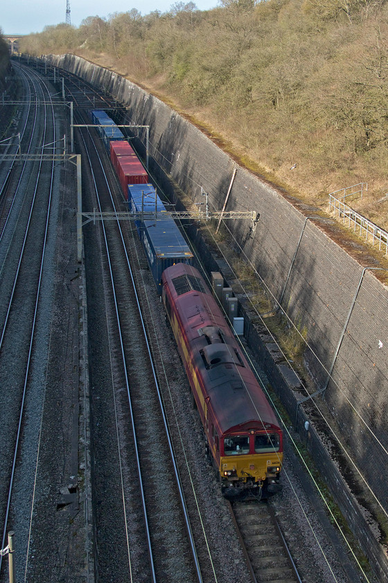 66126, 13.51 DIRFT-Ripple Lane FLT (4L48, 13L), Roade cutting 
 Direct Rail Services has been hiring in extra locomotives to cover its flows. The 13.51 Daventry to Purfleet (terminated at Ripple Lane) is hauled by an ex EWS (now DB) 66126. It is believed that DRS is going to rebrand the locomotives that it has acquired but how far it will go with this is still yet to be seen. The train is seen labouring at a very slow speed up the 1:200 gradient from Northampton through Roade cutting. 
 Keywords: 66126 13.51 DIRFT-Ripple Lane FLT 4L48 Roade cutting DB DRS